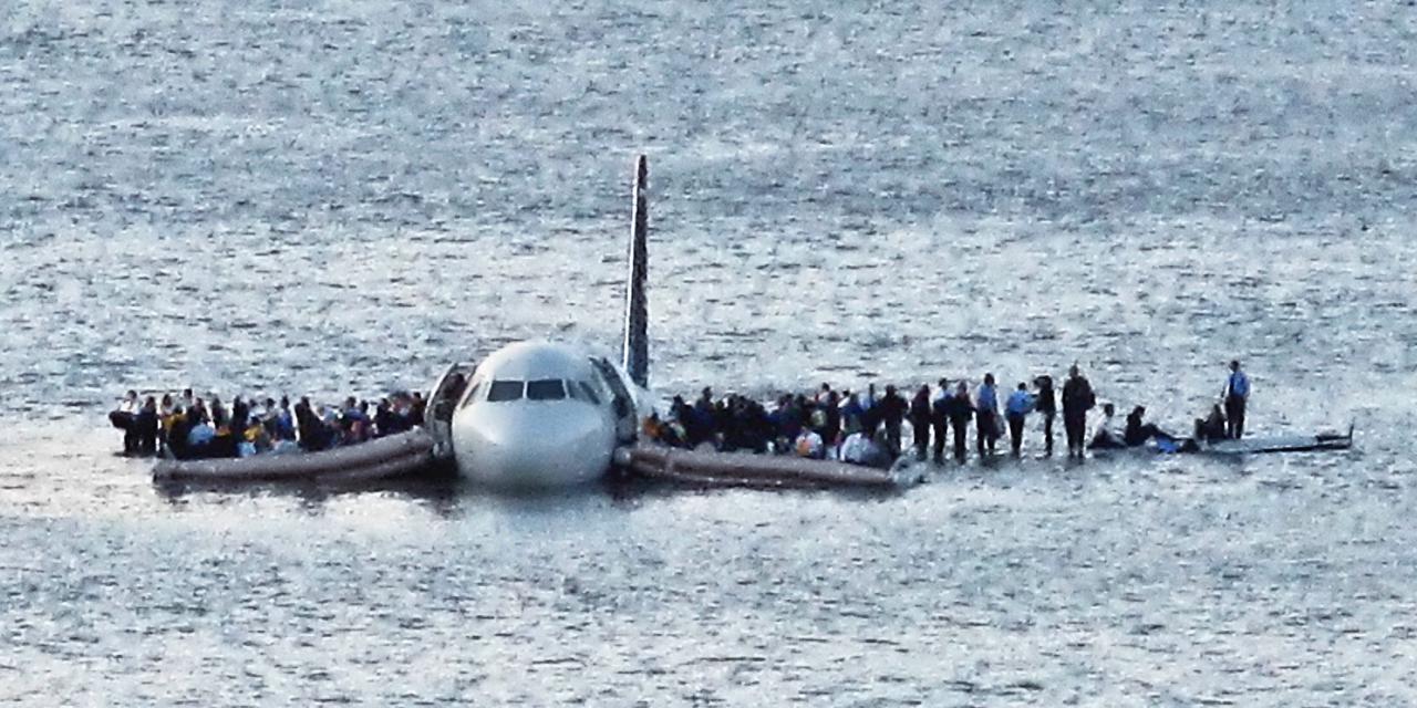 In this Thursday Jan. 15, 2009 file photo, airline passengers wait to be rescued on the wings of a US Airways Airbus 320 jetliner that safely ditched in the frigid waters of the Hudson River in New York, after a flock of birds knocked out both its engines. The audio recordings of US Airways Flight 1549, released Thursday, Feb 5, 2009 by the Federal Aviation Administration, reflect the initial tension between tower controllers and the cockpit and then confusion about whether the passenger jet went into the river. (AP Photo/Steven Day)